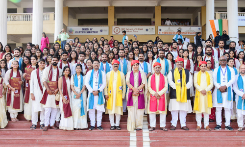 Group photo of graduates and faculty members in traditional attire at a convocation ceremony.