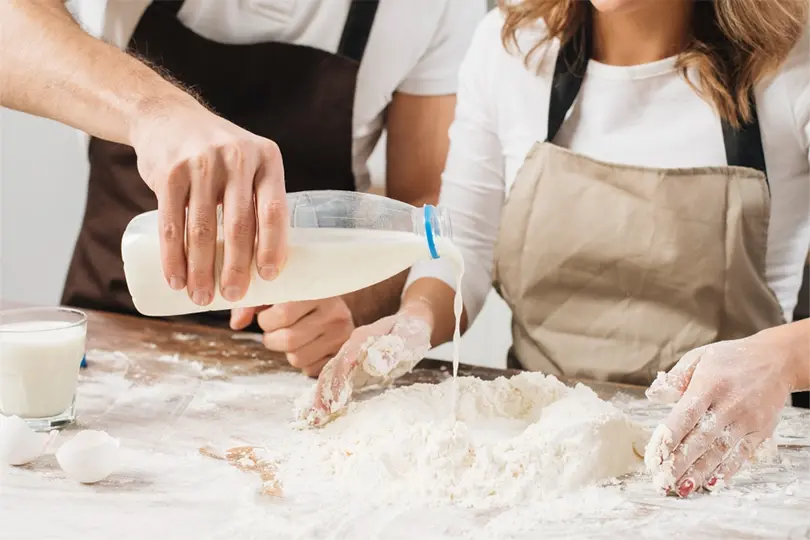 Two person making cheese